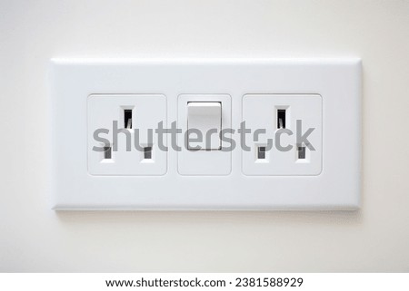 White wall mounted socket board with two electrical sockets and a switch. The socket board is isolated on a white background Royalty-Free Stock Photo #2381588929