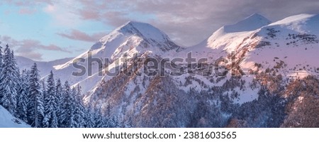 Pirin, Bulgaria winter travel vacation nature panoramic background with snow covered mountain peaks and sunset sky with clouds close-up Royalty-Free Stock Photo #2381603565