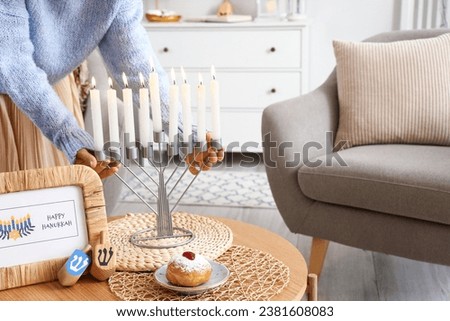 Jewish woman with menorah for Hannukah at home, closeup
