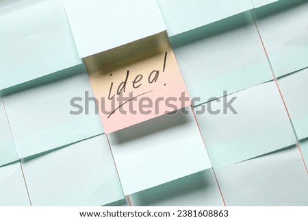 Sticky notes and sheet with word IDEA as background. Business idea concept