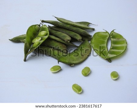 Closeup of Indian Hyacinth Beans or Avarekai with and without peeled seeds isolated on white background