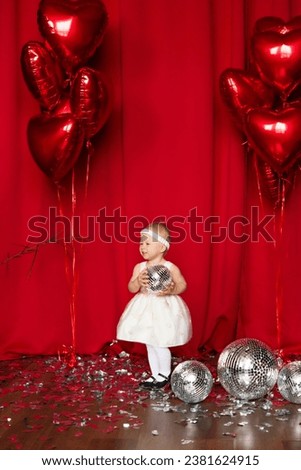 Smiling child with a disco ball. Party and disco. Concept of children's emotions. Portrait of lovely toddler little baby child with white dress