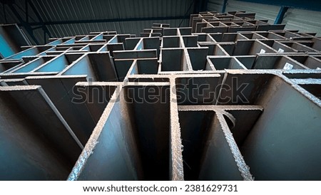 Steel beams production. Metal girders stack on project construction , steel h-beam, selective focus, Raw materials used in building construction. Royalty-Free Stock Photo #2381629731