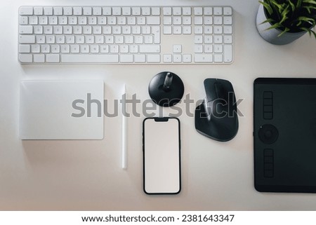 Smart phone empty screen mockup. Mouse and graphit tablet. Designer tools. Keyboard, touchpad. Top view desk.