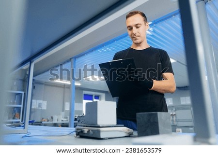Engineer measures size and controls quality of concrete cube in laboratory. Concept industry lab for testing building materials. Royalty-Free Stock Photo #2381653579