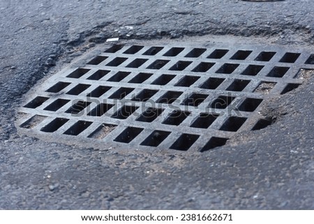 Close up view of manhole cover or metal grate of road drainage