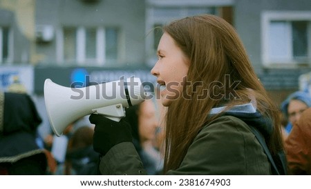 Young adult female feminist demonstration. Gender rights feminism fight. Women march movement power sign equality. Gender woman strike empowerment action. Social message. Crowd people city street day. Royalty-Free Stock Photo #2381674903