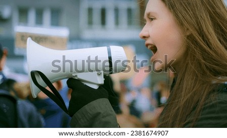 Young adult female feminist demonstration. Gender rights feminism fight. Women march movement power sign equality. Gender woman strike empowerment action. Social message. Crowd people city street day. Royalty-Free Stock Photo #2381674907