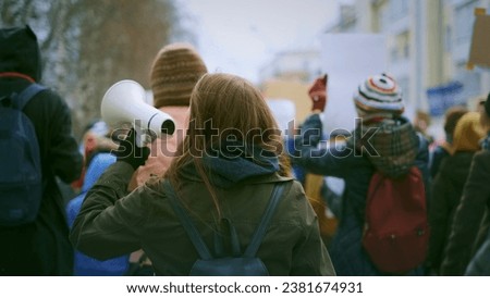 Young adult female activist feminist demonstration. Gender feminism fight resistance. Women march movement power sign equality. Strike empowerment action. Activist resistance. People city street day. Royalty-Free Stock Photo #2381674931