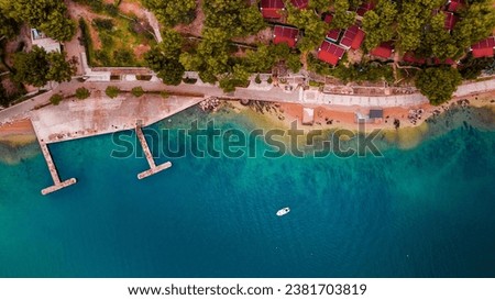 An aerial view of an empty marina situated on a shoreline: Hidrobaza, Pula Royalty-Free Stock Photo #2381703819