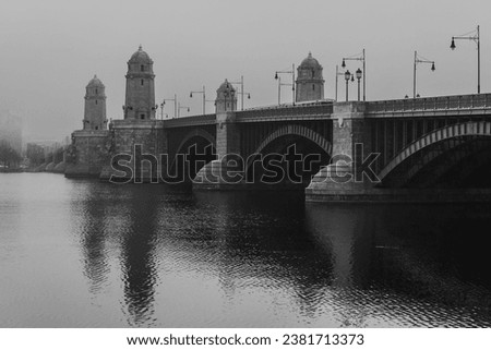 A black and white photograph of a the Longfellow Bridge in Boston over the Charles River
