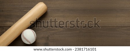 Baseball bat and ball on wooden table, top view. Banner with space for text