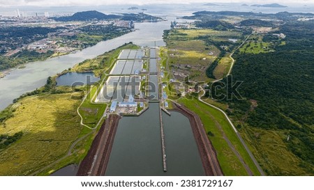 Panama Canal, Canal locks, Maritime Transit, container ship, Gatun Lake, climate change, Panama mining, tug Royalty-Free Stock Photo #2381729167