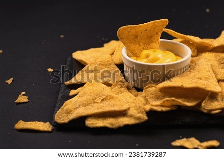 Nachos and sauce. Cheese sauce with nachos. Ketchup with nachos. Royalty-Free Stock Photo #2381739287