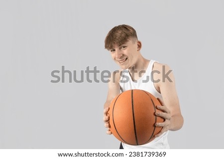 Caucasian teenage boy holding a basketball