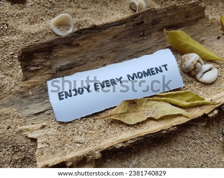 The writing enjoy every moment on the beach sand background.