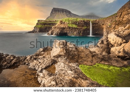 Gasadalur village and Beautiful waterfall, Vagar, Faroe Islands, Denmark. Royalty-Free Stock Photo #2381748405