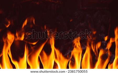 Flames in fireplace. Texture background isolated on a black background