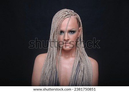 White girl with African braids and bright makeup. photo in the studio.
