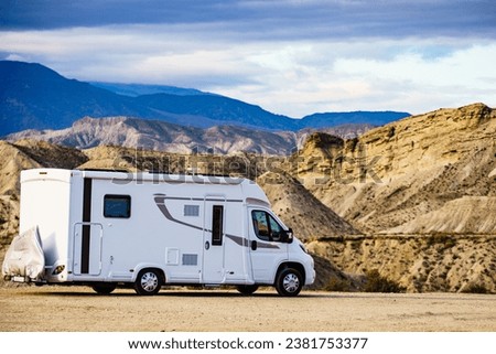 Caravan recreational vehicle camping in Tabernas desert, Almeria Spain. Traveling with motorhome. Royalty-Free Stock Photo #2381753377
