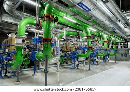 Industrial interior chiller and boiler HVAC heating ventilation air conditioning system and pipping line of industrial construction at boiler pump room system in the factory Royalty-Free Stock Photo #2381755859