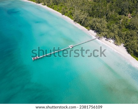 An aerial shot of the Ao Phrao beach on Koh Kood island in Thailand surrounded by the blue sea