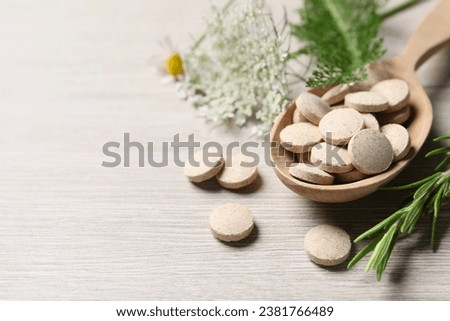 Pills and herbs on wooden table, closeup with space for text. Dietary supplements Royalty-Free Stock Photo #2381766489