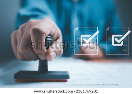 Businessman using rubber stamping on paper with correct sign mark symbol and electronic doc icon for document approve and project pass concept. Royalty-Free Stock Photo #2381769201