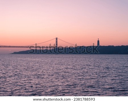 An aerial sunrise view of the 25 de Abril bridge in Lisbon, Portugal. Shot from public property adjacent to the Belem Tower