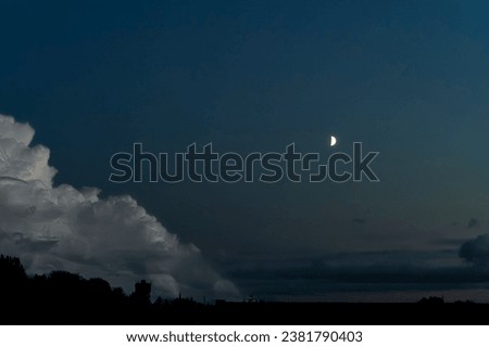 A mood picture of beautifull clouds with the moon on blue hour. Beautifull moon and clouds background.  
 Background in the early evening of beautiful white clouds together with a crescent moon.