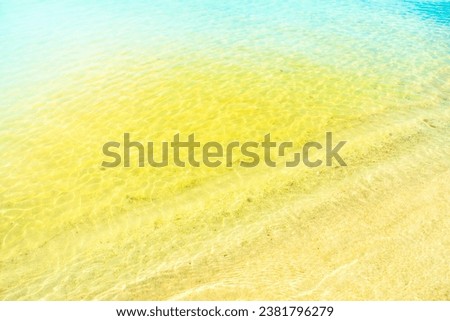 Calm waves on an empty sandy beach. Romantic background on the theme of vacation and a pleasant, relaxing holiday.
