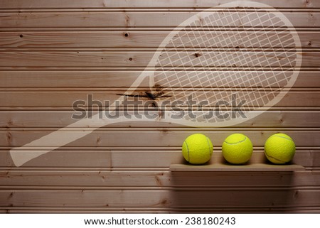 Darkened wall with sports equipment other than a place where was hanging a tennis racket.