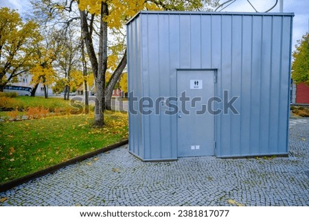 public toilet building. Front view of modern toilet. Outdoor toilet facade with male female WC sign. Toilet in an urban environment.