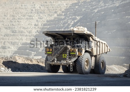Mining trucks come in various sizes, but some of the largest models can have payloads of over 400 tons. Their massive size allows them to transport large quantities of material efficiently. Royalty-Free Stock Photo #2381821239