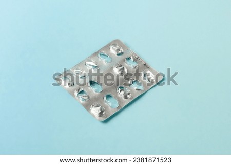 empty blister pack of pills on blue background. healthcare and medicine concept Royalty-Free Stock Photo #2381871523