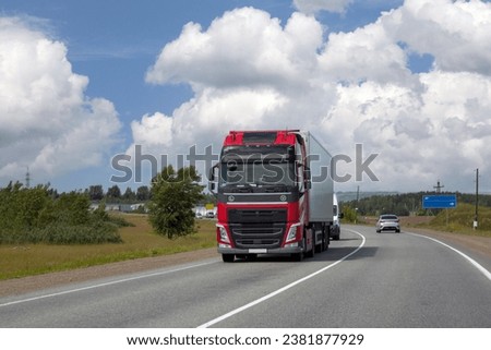 A truck is driving along the highway outside the city. Logistics, transport.