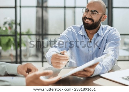 Businessman hand signing contract paper at the desk