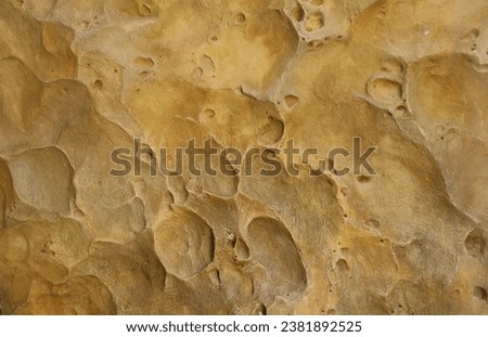 Combination of stone relief like a orange planet surface. Brown stone with abnormal relief shape with specific light Royalty-Free Stock Photo #2381892525