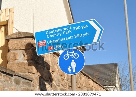Information Sign 'Chatelherault Country Park' on Steel Pole beside Stone Wall   Royalty-Free Stock Photo #2381899471