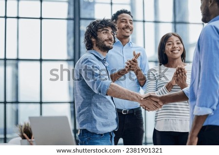 Successful Business Collaboration: Executives Greet with Handshake in Office Royalty-Free Stock Photo #2381901321