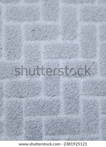 Closeup of a white brick way covered in snow