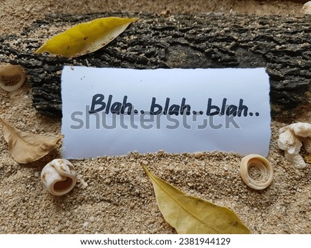 Blah blah blah writing on beach sand background.