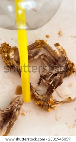 A picture of chicken bones and yellow straw