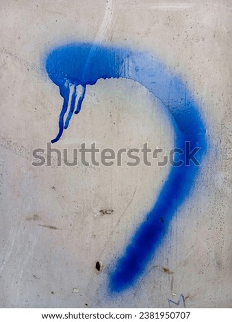 Abstract blue paint stroke background. Blue paint brush stroke on cement wall. Dirty concrete cement wall. Grungy wall texture.
