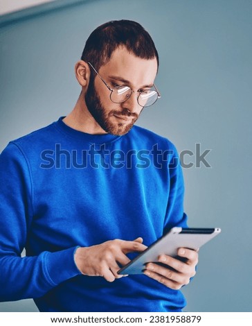 male blogger typing publication on tablet chatting with followers in social networks Royalty-Free Stock Photo #2381958879