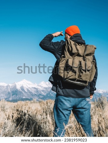 Young hipster guy enjoying breathtaking scenery of wild nature discover national park Royalty-Free Stock Photo #2381959023