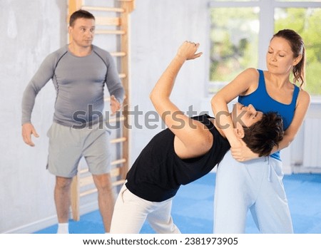 Woman makes a choke hold in self-defense trainin