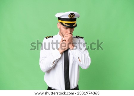 Airplane pilot man over isolated background is suffering with cough and feeling bad