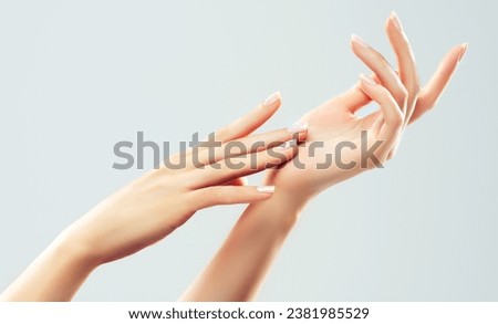 Hand skin care. Closeup of beautiful woman hands with  light manicure on nails . Cream for hands and treatment.