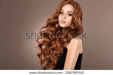 Beautiful laughing Redhead model  girl , with long curly red hair . Smiling  woman hairstyle  curls wavy . Fashion , beauty and makeup portrait
